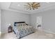 Relaxing main bedroom with tray ceiling, a king bed, and en suite bathroom access at 252 Broadleaf Dr, Denver, NC 28037
