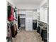 Spacious walk-in closet with custom shelving, ample hanging space, and neutral carpeting at 252 Broadleaf Dr, Denver, NC 28037