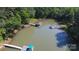 Stunning aerial view of a private lake with boat docks surrounded by lush greenery at 2721 Nance Cove Rd, Charlotte, NC 28214