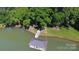An aerial view of the covered pier on the lake, surrounded by trees at 2721 Nance Cove Rd, Charlotte, NC 28214