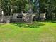Spacious backyard featuring a home with an inviting deck, surrounded by mature trees and lush green grass at 2721 Nance Cove Rd, Charlotte, NC 28214