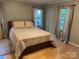 Bedroom with a bed, hardwood floors, and curtains covering the windows at 2721 Nance Cove Rd, Charlotte, NC 28214