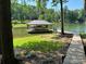 Scenic view of a covered boat dock on a serene lake, surrounded by green trees at 2721 Nance Cove Rd, Charlotte, NC 28214