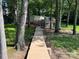 Charming lakefront home surrounded by mature trees and lush greenery with a wood boardwalk at 2721 Nance Cove Rd, Charlotte, NC 28214