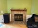 Inviting living room featuring a cozy fireplace with decorative tile surround and mantle at 2721 Nance Cove Rd, Charlotte, NC 28214