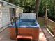Outdoor hot tub on a wooden deck, set against a backdrop of lush trees at 2721 Nance Cove Rd, Charlotte, NC 28214