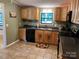 Kitchen featuring wooden cabinets and drawers, tile flooring, and dark countertops at 2721 Nance Cove Rd, Charlotte, NC 28214