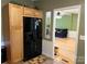 A kitchen and doorway lead into a living area with couch and ceiling fan at 2721 Nance Cove Rd, Charlotte, NC 28214