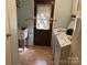 Functional laundry room with a utility sink, a door with blinds, and a washer and dryer setup at 2721 Nance Cove Rd, Charlotte, NC 28214