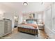 Sunlit bedroom with a large bed, soft bedding, and modern furnishings, and an attached bathroom at 3006 Khan Park Dr # 69, Charlotte, NC 28206