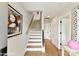 Bright entryway features hardwood floors, white staircase, and modern artwork at 3006 Khan Park Dr # 69, Charlotte, NC 28206