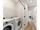 Functional laundry room with modern washer and dryer, storage shelves, and easy access at 3006 Khan Park Dr # 69, Charlotte, NC 28206