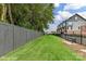 Private backyard showcasing a lush green lawn, modern fencing, and convenient access to nearby community amenities at 3010 Khan Park Dr # 68, Charlotte, NC 28206