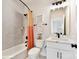 Bright bathroom featuring a vanity with white cabinets, a large mirror, and a tiled shower-tub combo at 3010 Khan Park Dr # 68, Charlotte, NC 28206