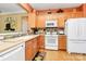 Cozy kitchen boasts wood cabinetry, modern appliances, and a functional design, creating a comfortable cooking space at 3079 Azalea Dr, Fort Mill, SC 29707