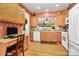 Efficient kitchen layout featuring wood cabinetry, modern appliances, and seamless connection to a home office space at 3079 Azalea Dr, Fort Mill, SC 29707