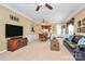 Bright living room with a dining area, a large TV, hardwood furniture, and access to the front door and backyard at 3079 Azalea Dr, Fort Mill, SC 29707