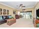 Bright living room with hardwood furniture, a large TV, and backyard access through a glass-paned doorway at 3079 Azalea Dr, Fort Mill, SC 29707