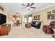 Spacious living room with a dining area, hardwood furniture, a large TV, and access to the front door and backyard at 3079 Azalea Dr, Fort Mill, SC 29707