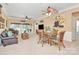 Open-concept living room with a dining area, multiple ceiling fans, and a view to the backyard through large windows at 3079 Azalea Dr, Fort Mill, SC 29707