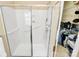 All-white shower with glass doors, grab bars, and storage shelves for convenience at 3079 Azalea Dr, Fort Mill, SC 29707