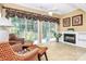 Sun room with lots of natural light from large windows and sliding glass door, plus a fireplace and wicker furniture at 3079 Azalea Dr, Fort Mill, SC 29707