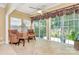 Bright sun room with wicker furniture and access to the backyard through large windows and a sliding glass door at 3079 Azalea Dr, Fort Mill, SC 29707