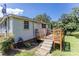 A wooden deck, accessible by stairs, offers a cozy outdoor space, next to a small side yard at 3419 Boat Club Rd, Belmont, NC 28012