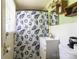 Cozy bathroom with a charming seashell shower curtain, a white sink, and ample storage at 3419 Boat Club Rd, Belmont, NC 28012