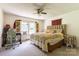 Bedroom with a large bed, desk and chair, ceiling fan, and bright windows at 3419 Boat Club Rd, Belmont, NC 28012