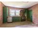 Rustic kitchen with brick walls, green cabinets, and modern appliances at 3419 Boat Club Rd, Belmont, NC 28012