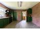 The charming kitchen features exposed brick walls, wood floors, and painted cabinets at 3419 Boat Club Rd, Belmont, NC 28012