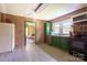 Spacious kitchen featuring classic brick walls, green cabinetry, and modern appliances, perfect for cooking at 3419 Boat Club Rd, Belmont, NC 28012