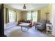 Cozy living room featuring soft carpet, bright windows and comfortable seating for relaxation at 3419 Boat Club Rd, Belmont, NC 28012