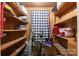 Walk-in pantry with wood shelves, filled with cleaning and household supplies at 3419 Boat Club Rd, Belmont, NC 28012
