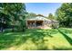 Rear exterior view of a brick home with a fenced yard and covered patio at 402 Scotland Dr, Kings Mountain, NC 28086