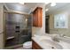 Updated bathroom featuring a tiled shower with glass door, and modern vanity at 402 Scotland Dr, Kings Mountain, NC 28086