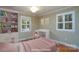 Charming bedroom with hardwood floors, a bright window, built-in shelving, and a cute desk area at 402 Scotland Dr, Kings Mountain, NC 28086