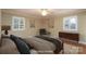 Cozy bedroom with hardwood floors, neutral paint, two large windows, and a ceiling fan at 402 Scotland Dr, Kings Mountain, NC 28086