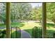 Inviting covered front porch framed by stately columns and wrought iron railings, overlooking the lush front yard at 402 Scotland Dr, Kings Mountain, NC 28086