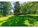 Lush front yard with mature trees, providing shade and curb appeal at 402 Scotland Dr, Kings Mountain, NC 28086