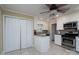 Well-lit kitchen with white cabinets and stainless steel appliances at 402 Scotland Dr, Kings Mountain, NC 28086