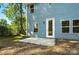 Back of home with blue siding and a concrete patio at 411 Patience Dr, Concord, NC 28025