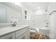 Bright bathroom featuring a single vanity, a soaking tub, and a window at 411 Patience Dr, Concord, NC 28025
