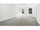 Bright bedroom with a ceiling fan and two windows providing ample natural light and outdoor views at 411 Patience Dr, Concord, NC 28025
