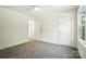 Bright bedroom features a ceiling fan, large windows and plush carpet flooring at 411 Patience Dr, Concord, NC 28025