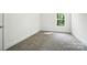 Bright bedroom features a window and plush carpet flooring at 411 Patience Dr, Concord, NC 28025