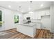 Charming kitchen featuring white cabinets, an island with seating, and stainless steel appliances at 411 Patience Dr, Concord, NC 28025