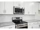 An efficient kitchen with granite countertops, stainless steel appliances, and white subway tile at 411 Patience Dr, Concord, NC 28025