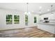 A kitchen with white cabinets, granite countertops, stainless steel appliances, and abundant natural light at 411 Patience Dr, Concord, NC 28025